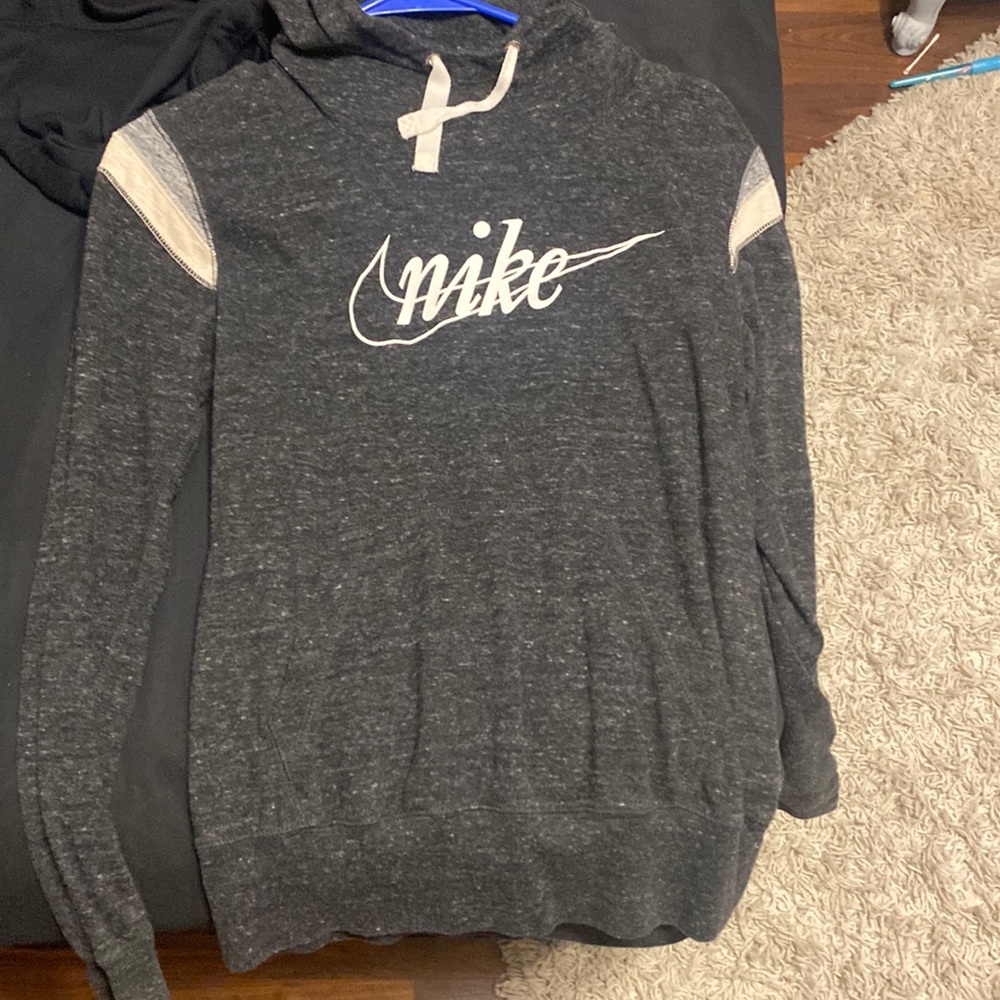 Dark grey Nike hooded sweater. Very light material and fits tight.